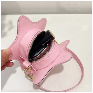 Pink star-shaped mini handbag interior view showing storage space for a lipstick