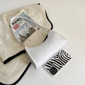 Minimalist white faux leather hobo bag with embossed crocodile pattern and shoulder strap