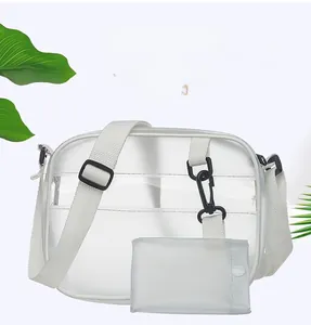 Detailed shot of transparent jelly crossbody bag with white strap and green leaf decor