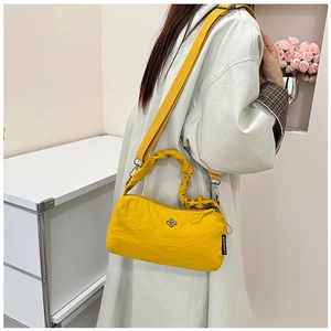 Nylon crossbody bag with ruched handle and adjustable strap on a female model