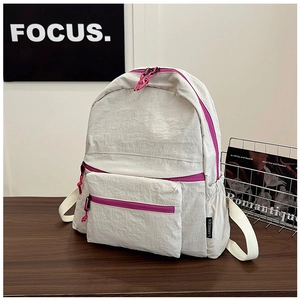 Detail of off-white lightweight nylon backpack with purple zippers and side pockets