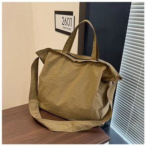 Detailed macro view of khaki canvas tote with natural texture and reinforced webbing straps