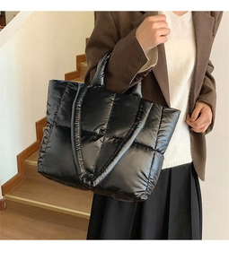 Close-up of black quilted nylon tote bag with puffer texture for daily commuting fashion