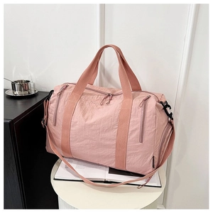 Detail of pink waterproof nylon travel bag with smooth zippers and sturdy handles