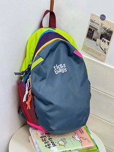 Detail of color-block backpack with dual zippers, mesh side pocket and logo print
