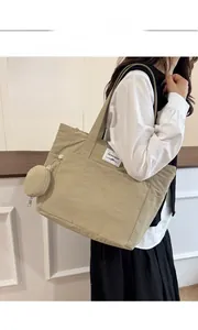 Detail of khaki nylon tote bag with small matching round purse and brand label