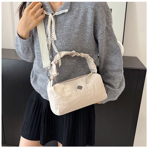 Detail of cream nylon crossbody bag with ruffled handle and metallic flower logo