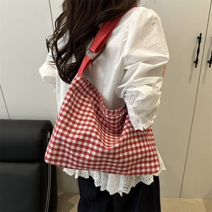 Chic red and white gingham canvas bucket bag with wide red shoulder strap for women