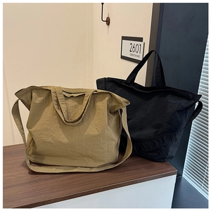 Detail of minimalist canvas tote bags in khaki and black with water-repellent texture
