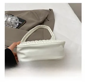 Detail showing durable wear-resistant base with quilted texture on white mini shoulder bag