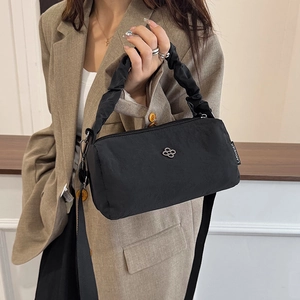 Chic black nylon cylinder handbag with ruched handle and clover logo in high-end look