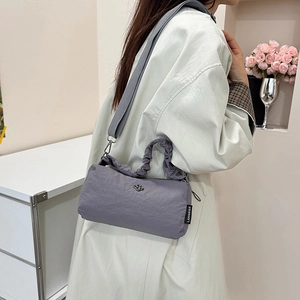 Minimalist grey nylon crossbody bag with pleated handle and adjustable wide strap