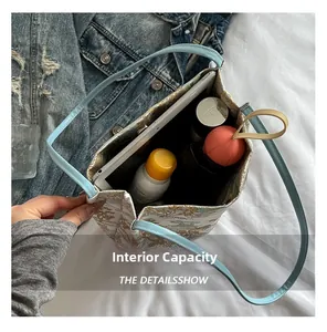 Top view showing large capacity of embroidery tote bag with tablet and daily items