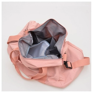 Detailed view of internal compartments and wet-dry separation pocket in pink gym bag