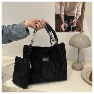 Detail of black corduroy tote bag with chain strap and matching coin purse set