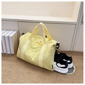 Nylon travel bag detail showing the separate side shoe compartment with sneakers inside