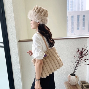 Dettaglio del set borsa tote in peluche beige chiaro e cappello con trapuntatura verticale