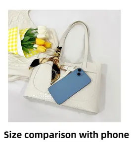 White crocodile pattern tote bag with decorative silk scarf and size comparison with phone