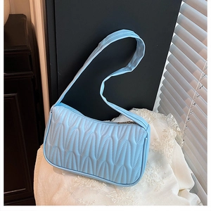 Detail showing light blue pleated texture on high-quality PU leather handbag surface