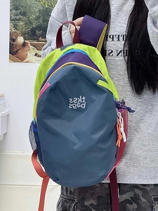 Detail view of colorful nylon backpack with side mesh pocket and stylish contrast straps