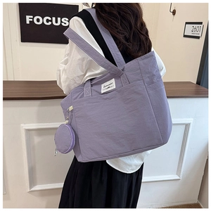 Detail of lavender purple nylon tote bag with small round coin purse attachment