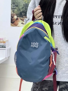 Detail view of colorful backpack with mesh side pocket and zipper closure with extension cord