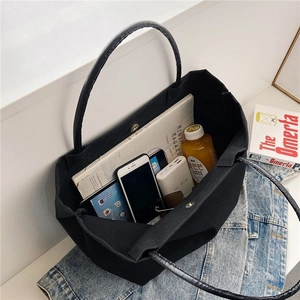 Detailed view of spacious black canvas bucket bag interior with magnetic closure