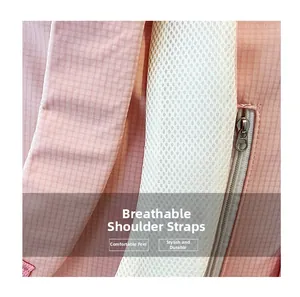 Close-up of pink grid backpack showing breathable mesh shoulder straps and durable metal zipper