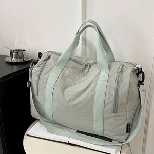 Large mint green nylon sports travel duffel bag with multiple zippers and adjustable strap