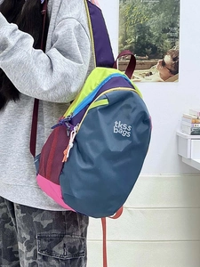 Detailed back view of a colorful waterproof contrast backpack on model