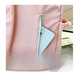 Close-up of pink checkered backpack featuring a secure back zipper pocket for smartphones