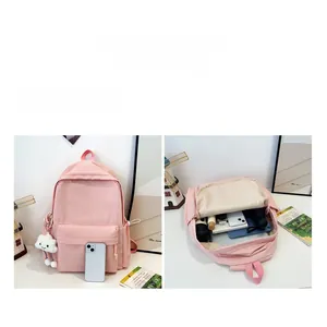 Pink checkered backpack with plush cloud charm showing large capacity interior compartments