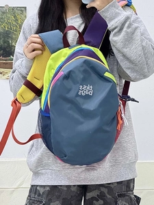 Close-up of contrast color backpack with breathable mesh straps and side pockets