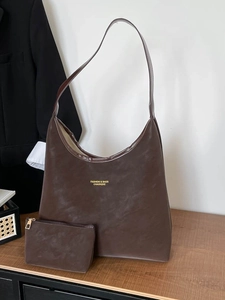 Deep brown suede large tote bag with matching pouch on wood surface for daily commuting