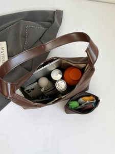 Dark brown faux suede tote bag with matching pouch shown in a high-angle capacity view