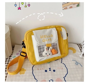 Détail du sac bandoulière en toile avec poche transparente et peluches de lapin mignon