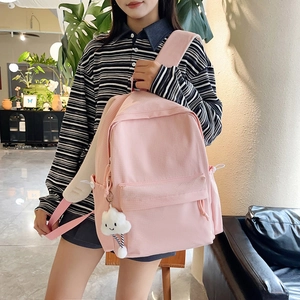 Pink lattice backpack with cloud charm showing lifestyle use for school and daily commute