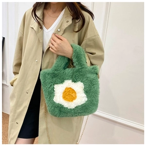 Green plush crossbody bag with fried egg decor and golden chain strap for winter style
