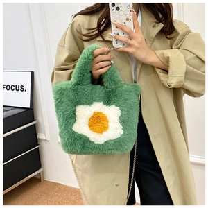 Detail of green faux fur crossbody bag with daisy floral pattern and gold chain strap