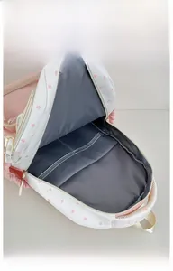 Internal display of school backpack with star print showing spacious dark grey lining