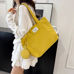 Bright yellow nylon tote bag with small round coin purse for women, daily commute style
