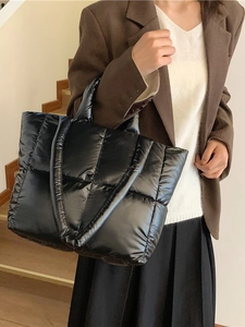 Chic black quilted puffer tote bag for women featuring a spacious and lightweight design