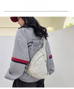 White nylon crossbody bag shown worn on back featuring adjustable strap and wrinkled texture