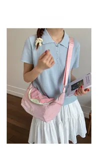 Pink crossbody bag featuring a guava fruit flap with embroidery and wide strap detail