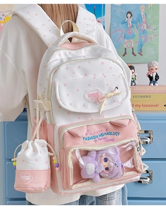 Detailed side view of two-tone backpack with star patterns and clear window pocket