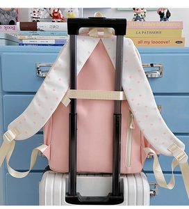 Pink cat star backpack featuring a luggage strap and shoulder straps with star patterns