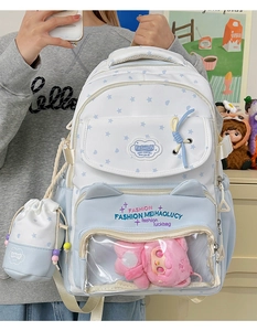 Star pattern school backpack with clear PVC front pocket and plush doll detail