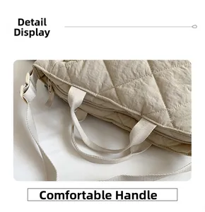 Detail view of quilted nylon tote bag featuring durable dual handles and metal zipper
