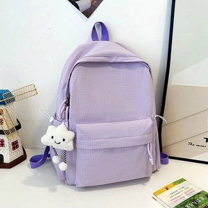 Detail of purple plaid backpack with a cute cloud plush charm and front zipper pocket