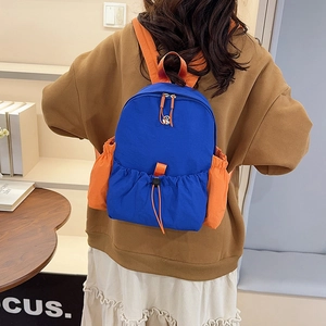 Detail eines blauen und orangen Rucksacks aus wasserfestem Nylon mit Seitentaschen